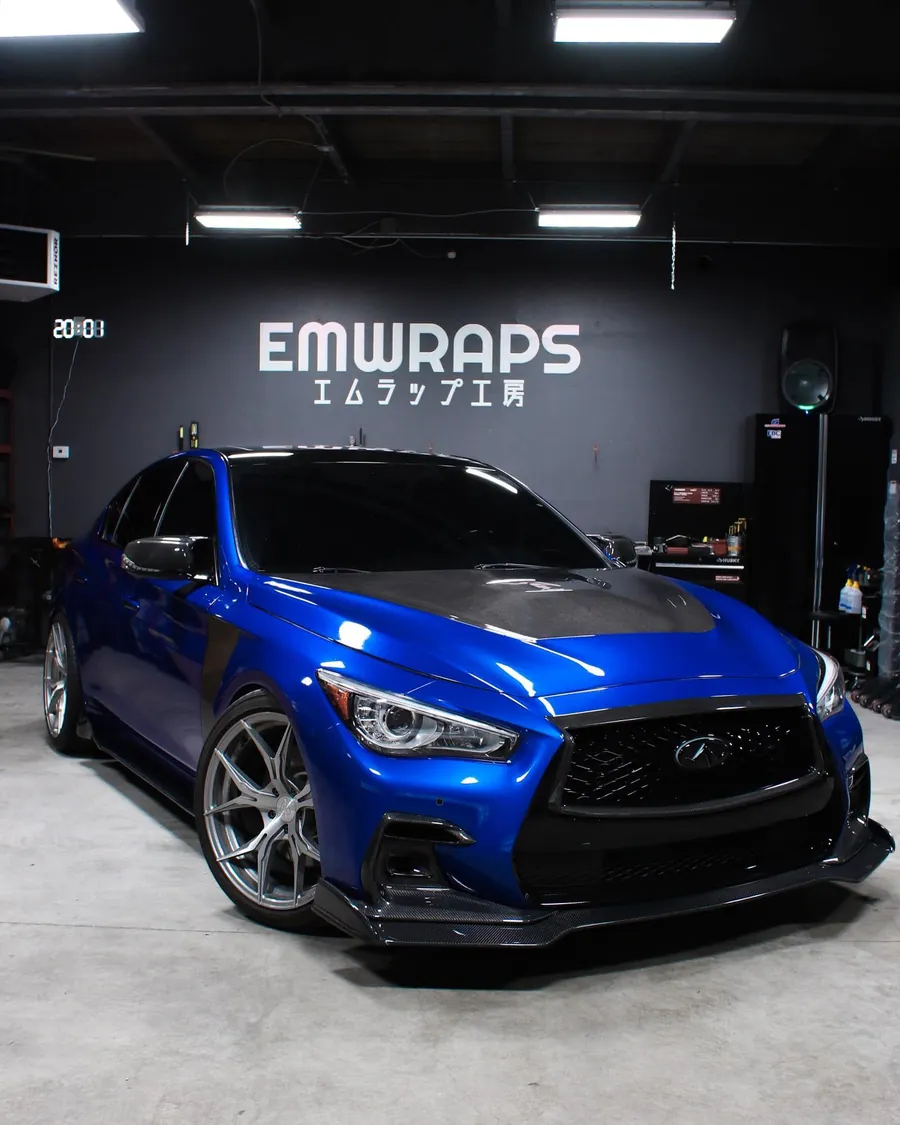 Blue Infiniti Q50 with a full carbon kit at the EMWRAPS shop