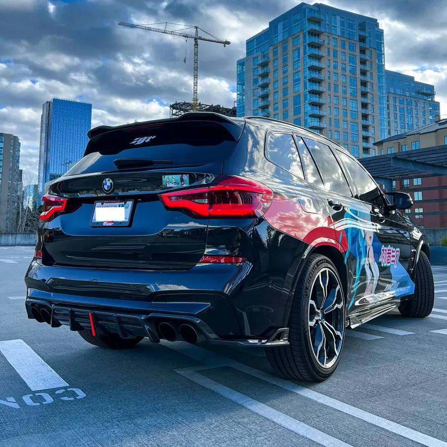 Rear of a black BMW X3 M with a full carbon kit
