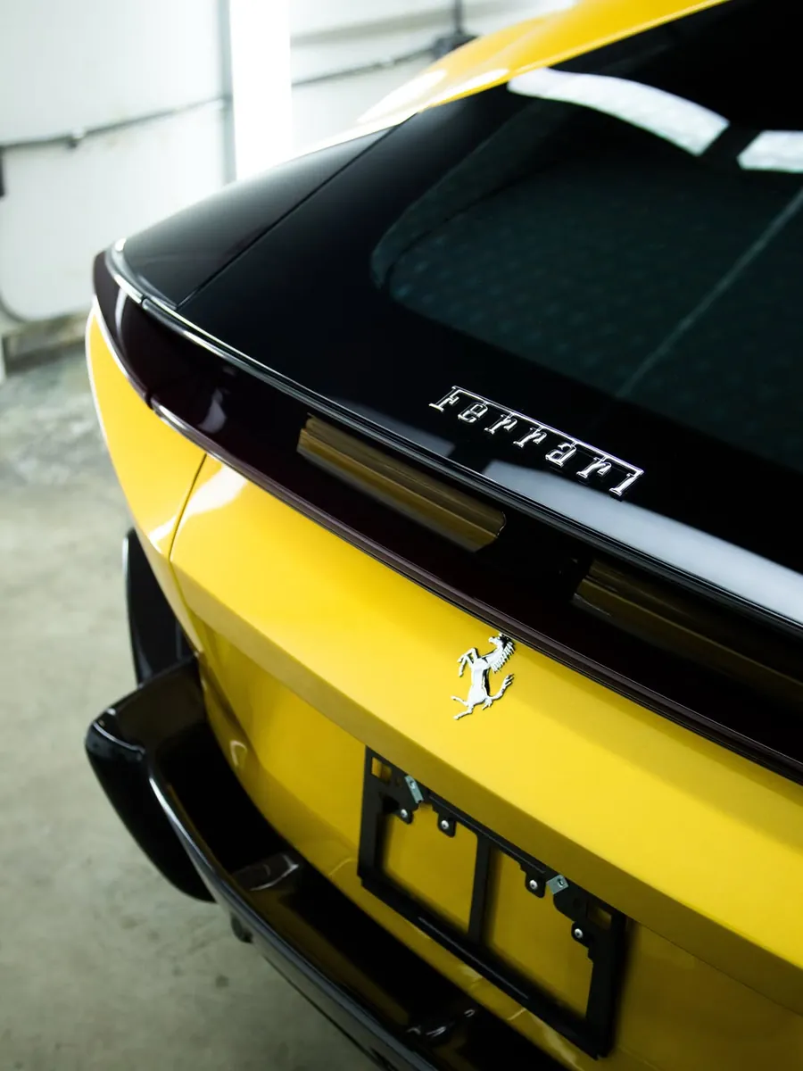 Yellow Ferrari 12Cilindri in the EMWRAPS install bay after full body PPF