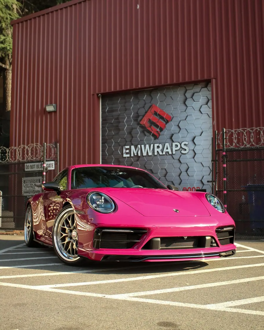 Pink Porsche 992.2 GT3 with full body clear PPF outside the EMWRAPS shop