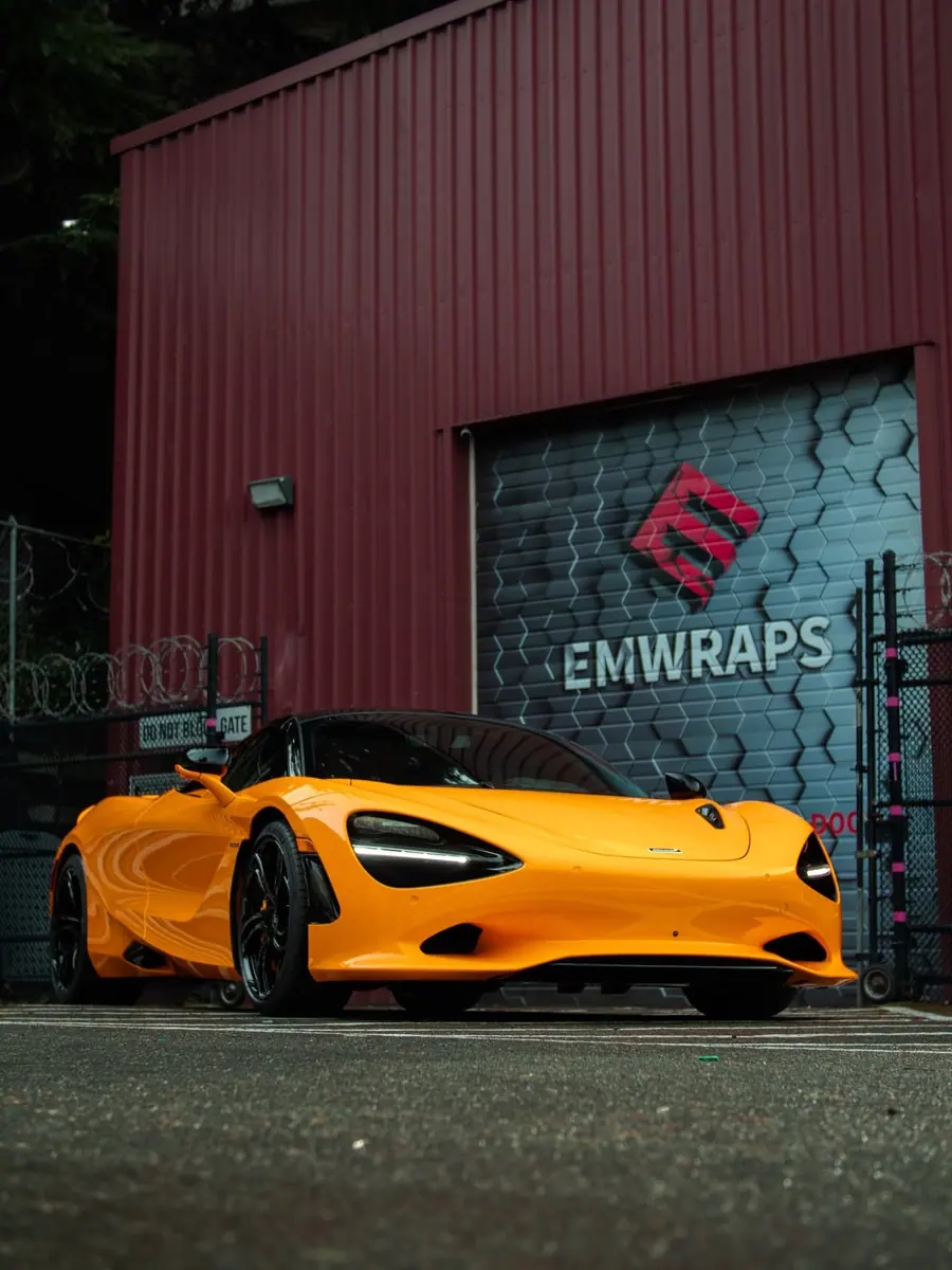 Orange McLaren 750S with clear PPF in front of the EMWRAPS shop