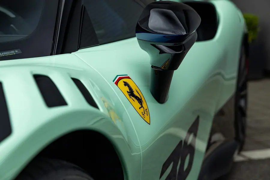 Front fender and mirror of a mint Ferrari SF90 XX under clear paint protection film