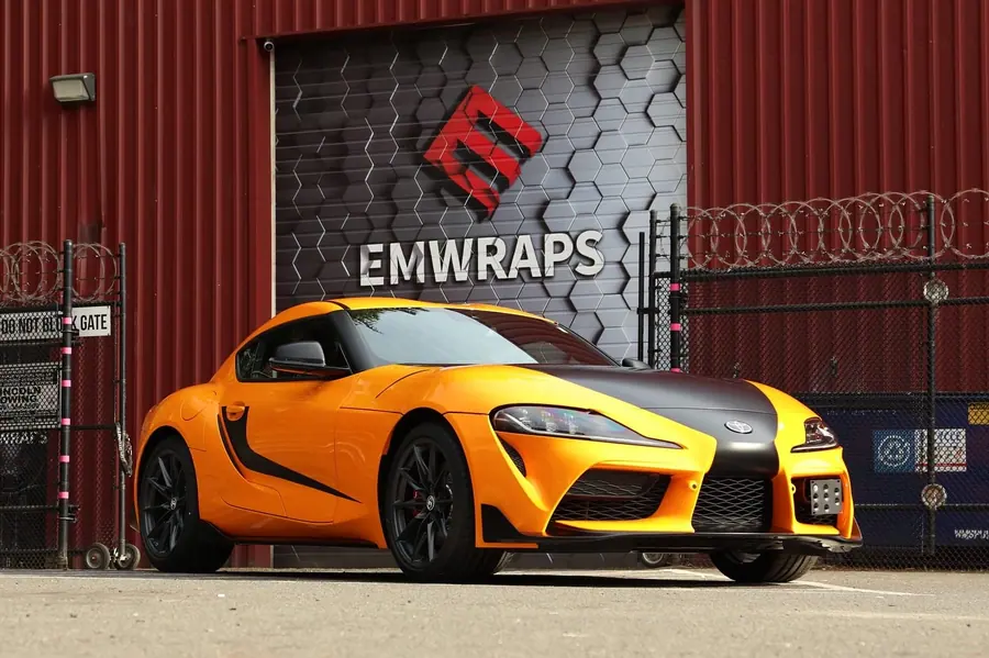 Toyota GR Supra in orange and matte black color PPF outside the EMWRAPS shop