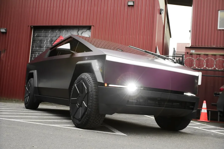 Tesla Cybertruck in matte iridescent black purple PPF outside the EMWRAPS shop