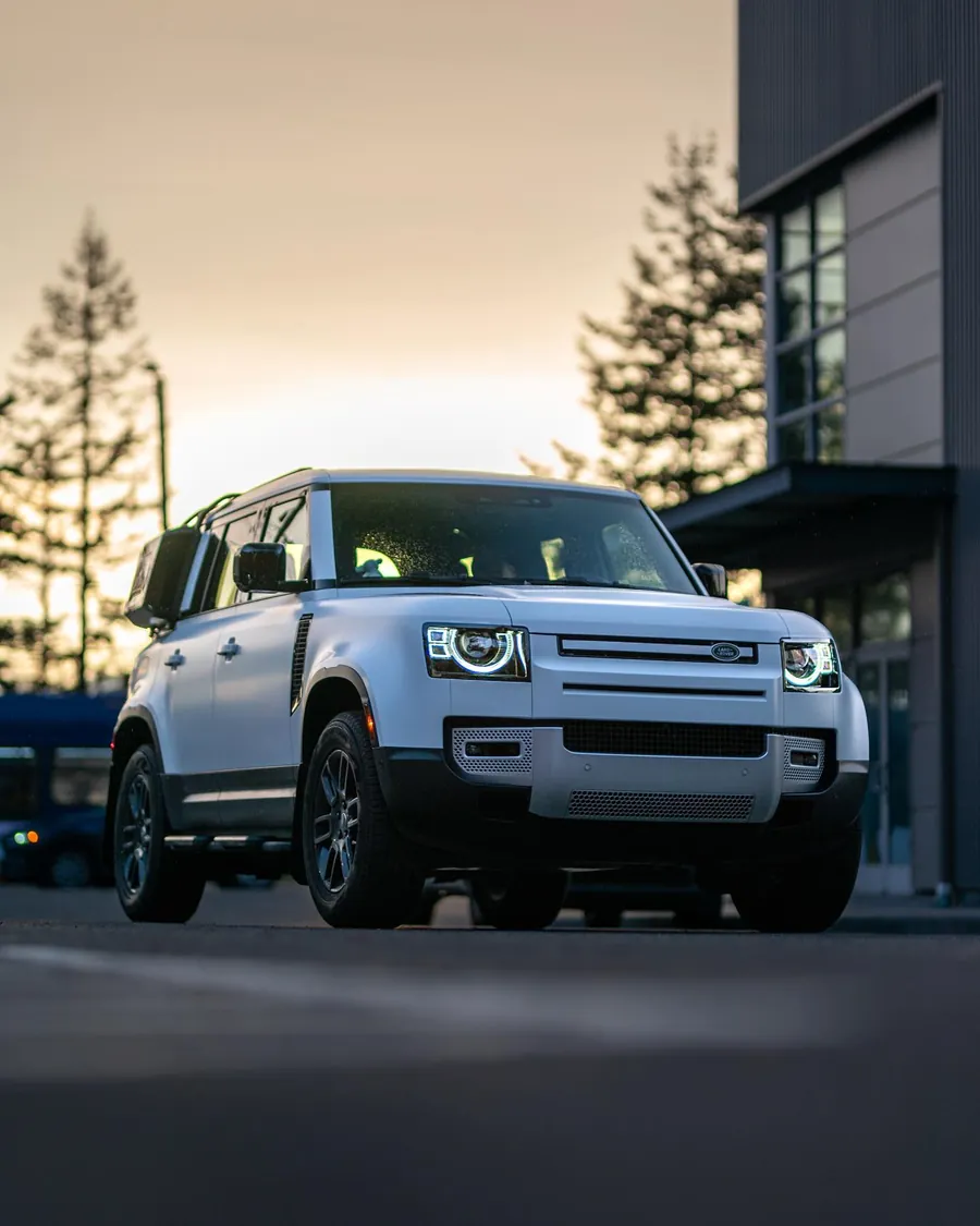 White Land Rover Defender in stealth PPF at dusk