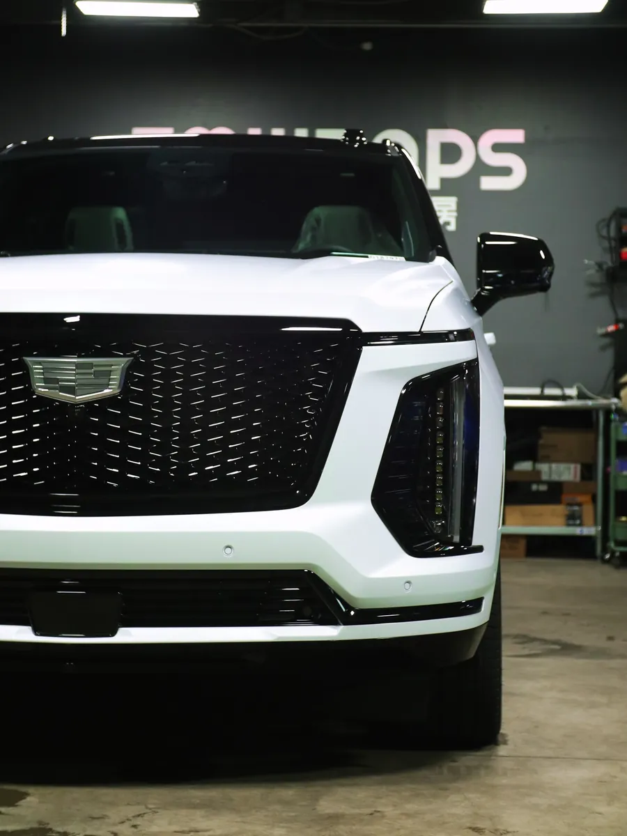 White 2025 Cadillac Escalade with a stealth PPF body and gloss black roof in the EMWRAPS shop