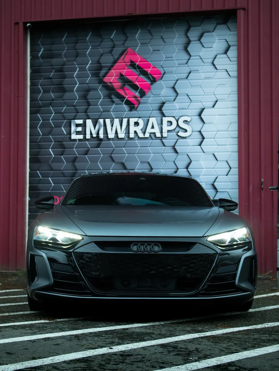 Grey Audi e-tron GT in full stealth PPF in front of the EMWRAPS door