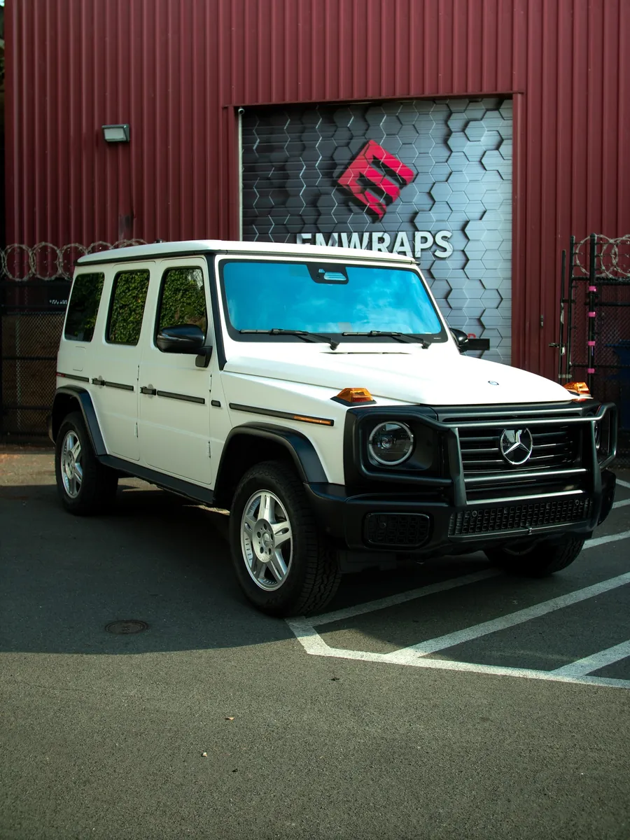 White Mercedes G-Class Stronger Than the 1980s edition in stealth PPF outside the EMWRAPS shop