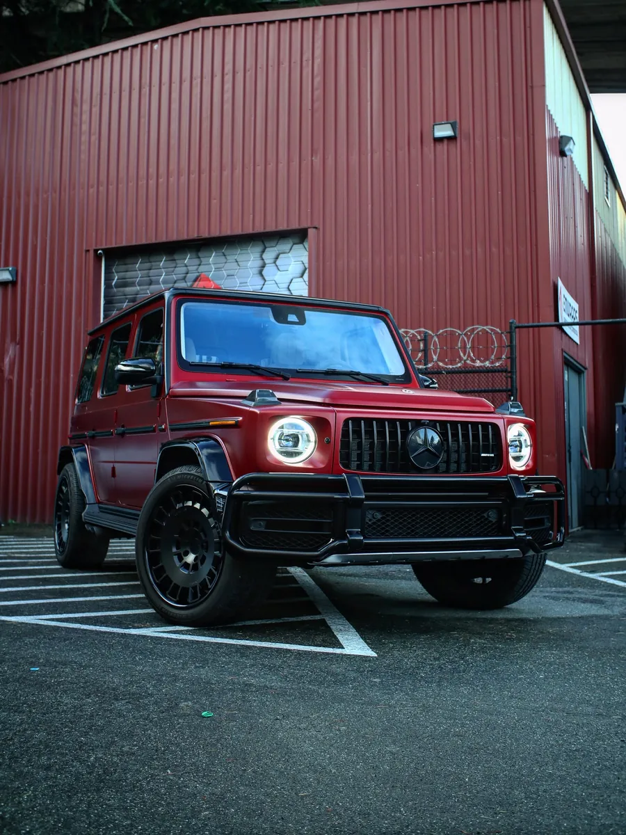Red Mercedes-AMG G 63 in satin stealth PPF outside the EMWRAPS shop