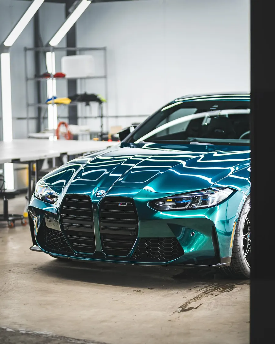 BMW M4 Competition in teal color PPF in the EMWRAPS install bay