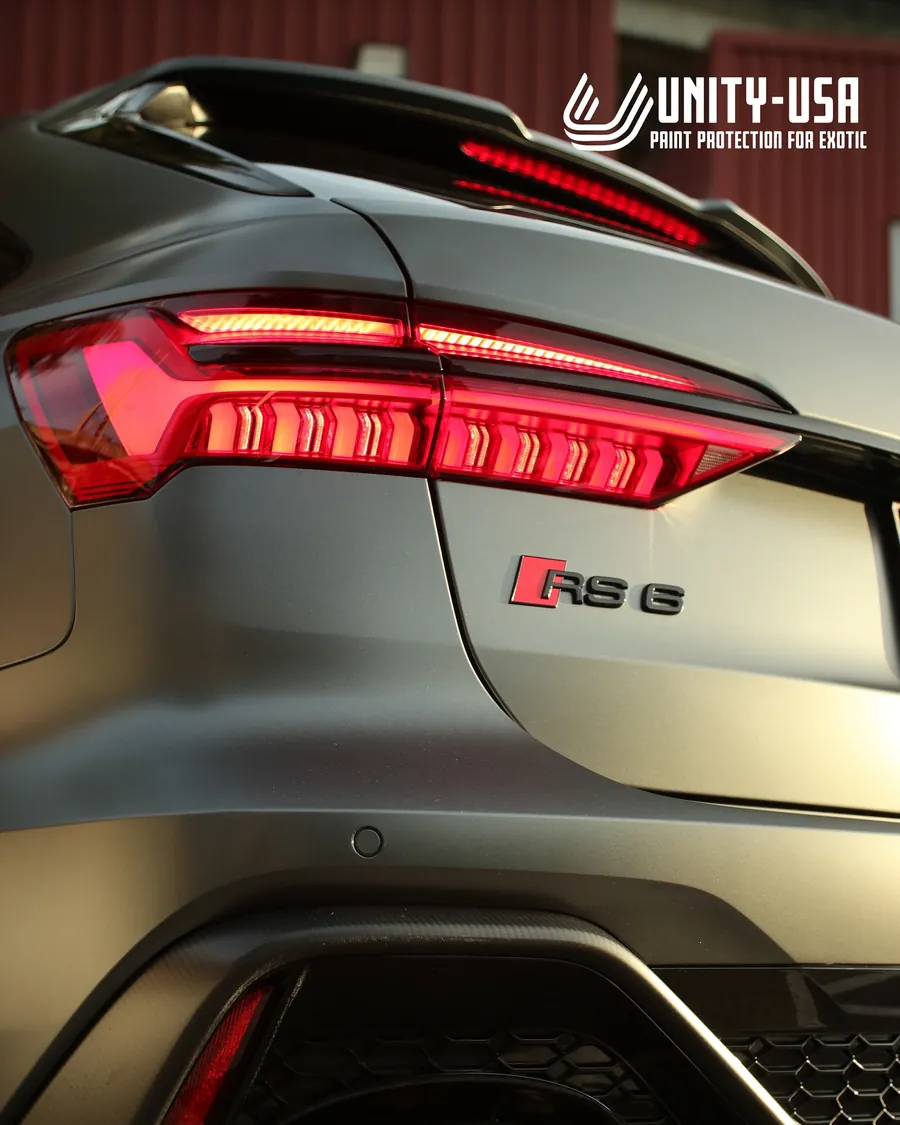 Grey Audi RS6 Avant in satin stealth PPF, rear badge and taillight