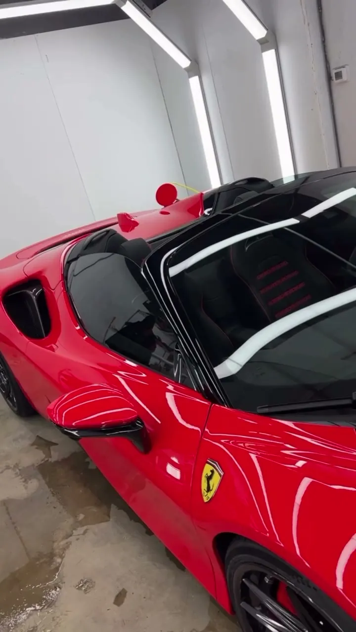Red Ferrari SF90 being polished and wrapped in clear PPF, then finished in the EMWRAPS bay