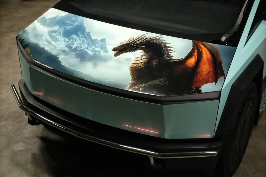 Tesla Cybertruck with a printed dragon design across the front