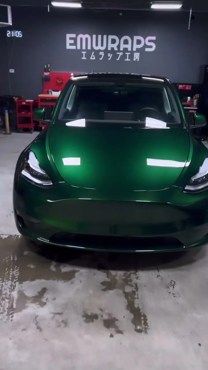 Tesla Model Y wrapped in green at the EMWRAPS shop