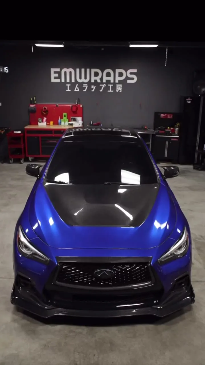 Blue Infiniti Q50 with a carbon hood at the EMWRAPS shop