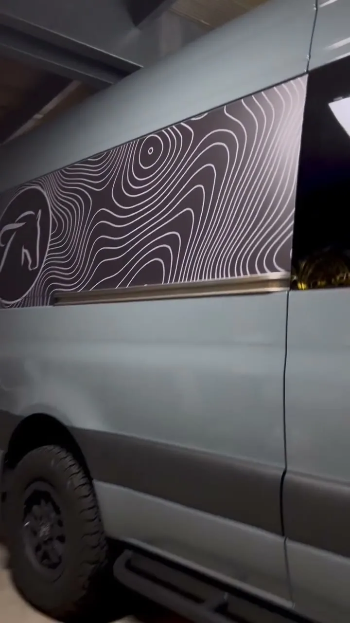 Grey Mercedes Sprinter van with topographic line graphics